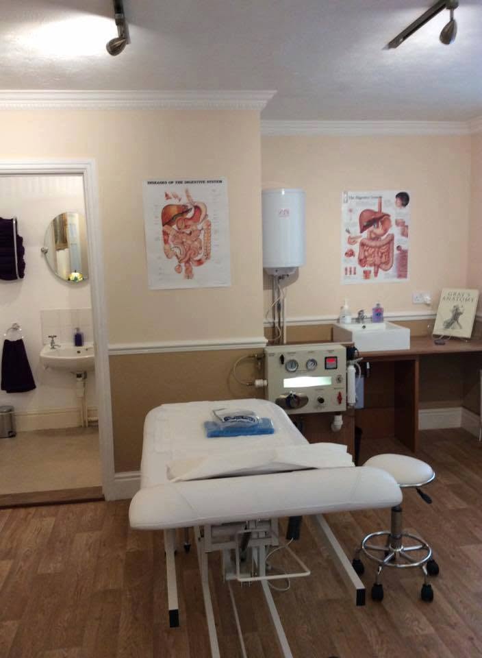 Private colonic hydrotherapy treatment room at Redmayne Lodge, Strensall, York — treatment couch, closed-system equipment and calm decor